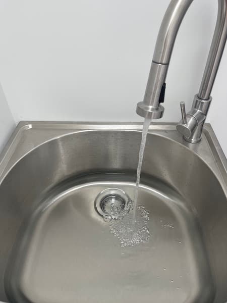 A sink filling up with water.