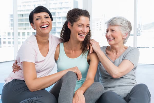A group of 3 smiling women.