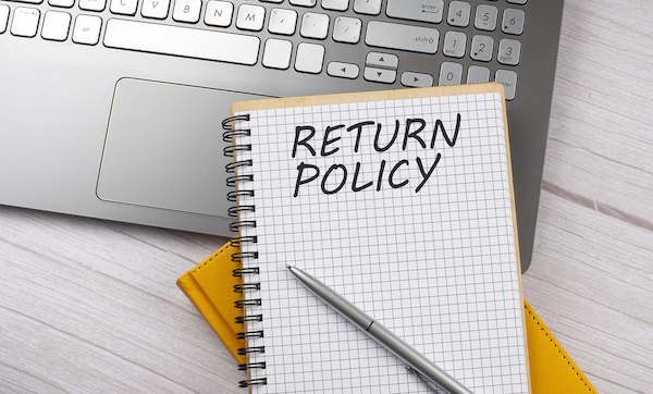 A notebook with a note that says "return policy"
