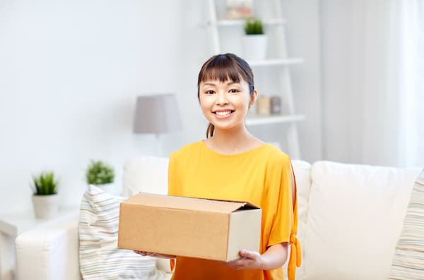 A woman getting ready to ship a box.