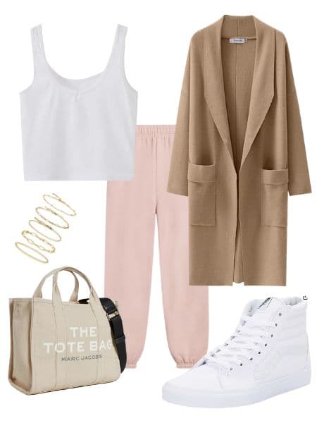 A womens outfit idea with a wool coat, pink sweatpants, white crop top, tote bag, white sneakers, and gold bracelets.