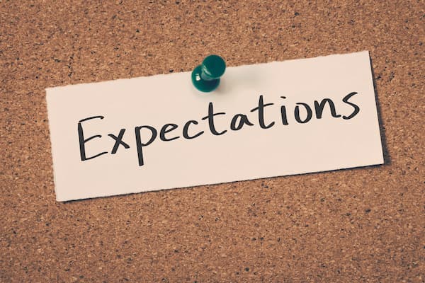An expectations sign hanging on a bulletin board.